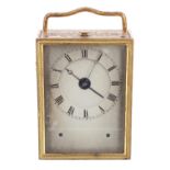 Interesting small French ormolu travel alarm clock, the sliding back door with winding and control