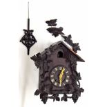 Black Forest two train cuckoo clock, the metal movement striking on a gong, 4.75" dial within a
