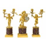 Fine French ormolu and rouge marble figural mantel clock garniture, the movement with platform