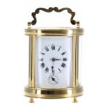 Small French oval carriage clock timepiece with alarm, the movement fitted with a bell flush to