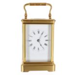 French carriage clock striking on a gong, within a gilded brass corniche case, 7" high; also