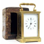 Carriage clock striking on a bell, within a corniche brass case, 6.5" high; also with an outer