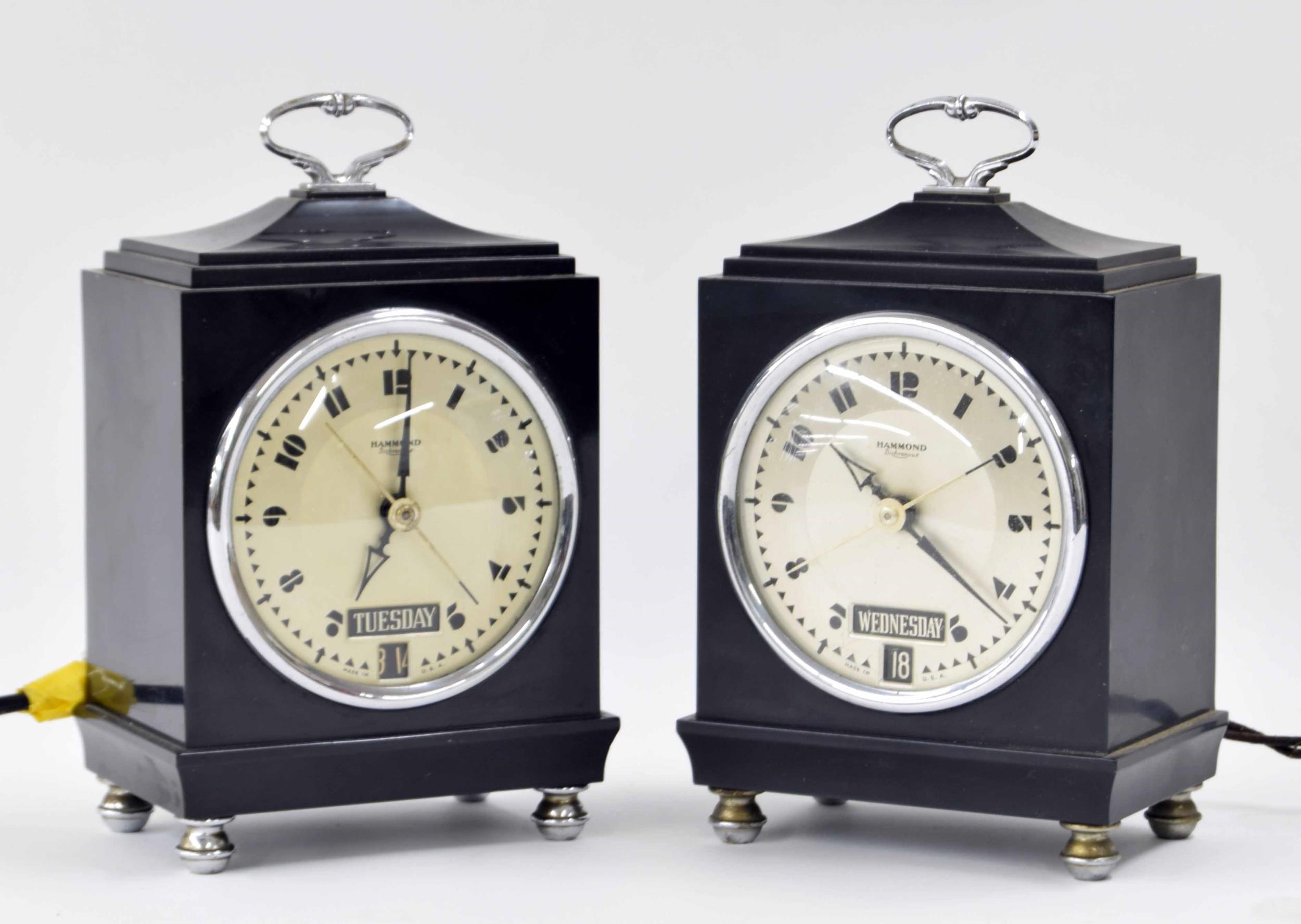 Two Hammond Bichronous electric mantel calendar clocks, within Bakelite cases surmounted by caddy