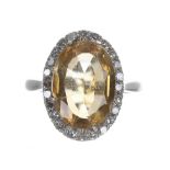 Platinum citrine and diamond oval ring, the citrine 4.15ct approx, in a surround of round-cut