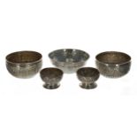 Two similar Indian white metal repousse decorated bowls, 4" and 4.25" diameter, 2" high; together