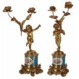 Attractive pair of French porcelain and ormolu figural twin branch candelabra, modelled as putti