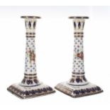 Pair of French 19th century porcelain candlesticks, decorated with gilt highlighted on blue