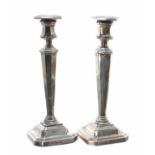 Pair of James Dixon & Sons Ltd silver candlesticks, with hexagonal columns raised on stepped