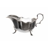 Frank Cobb & Co. silver sauce boat, with moulded scrolling rim and capped C-scroll handle, raised on