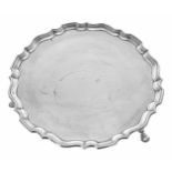 George V silver card tray, with moulded piecrust rim, raised on three feet, maker Hawksworth, Eyre &