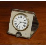 George V folding silver cased travelling eight day clock, within an engine turned cigarette case,
