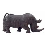 Large solid carved wood sculpture of a rhinoceros, 27" long, 12" high