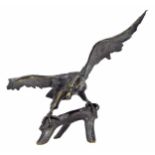 Decorative large gilt metal figure of an eagle with outstretched wings perched on a branch, 28"