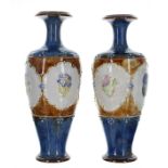 Pair of Royal Doulton stoneware vases, shape 8367, decorated with floral sprays within scrolling