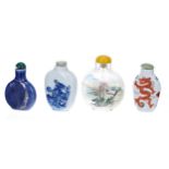 Four Chinese porcelain and glass scent bottles, the largest reverse painted glass example 3" high (
