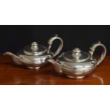 Pair of George IV silver teapots of compressed form, with capped handles and single reeded bodies,