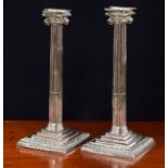 Pair of George III silver candlesticks, modelled as Corinthian reeded columns on stepped square