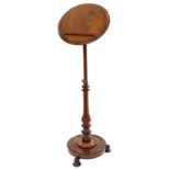Victorian mahogany adjustable music stand, the circular top fitted with a ledge and supported upon a