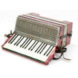 Hohner Carmen II twenty-four button piano accordion, red marble finish, case