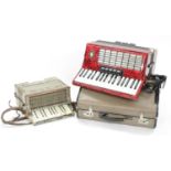 Weltmeister Stella piano accordion, with sixty buttons and five switches, red marble finish, case;