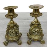 Pair of aesthetic brass candlesticks, with circular sconces over serrated drip pans, raised on