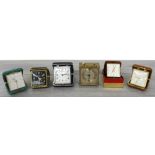 Selection of five folding travel clocks in cases; to include Bulova, Smiths, Swiza, etc.; also a