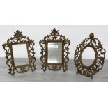Pair of French rococo gilt metal strut frames, with elaborate scrolling foliate surrounds, one