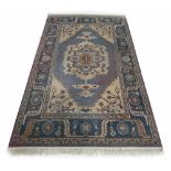 Persian pattern rug, on a teal ground densely decorated with central medallion within floral sprays,