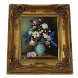 20th century - still life of flowers in a blue and white pottery vase on a table, signed B Hearn and