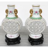 Pair of modern Chinese reticulated porcelain vases, of baluster flask form with gilt highlighted