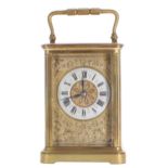 Carriage clock striking on a gong, the 2" cream enamel chapter ring enclosing a stylised floral