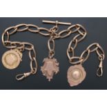 Good 9ct rose gold watch Albert chain, with three medallion fobs, T-bar and swivel clasps the oval