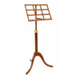 Contemporary satinwood adjustable music stand, the single ledge supported upon a faux bamboo