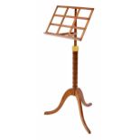 Contemporary satinwood adjustable music stand, the single ledge supported upon a faux bamboo