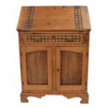 Arts & Crafts style pine bureau, the fall front with carved chequered board banding enclosing fitted