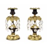 Pair of Regency gilt metal lustre candlesticks, with repousse drip pans over turned gilt and