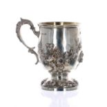 Attractive Victorian repousse silver pedestal christening mug, with foliate swags and C scroll