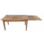 French fruitwood drawer leaf kitchen/refectory table, the plank top with single slim frieze drawer
