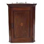 Georgian mahogany hanging corner cupboard, with moulded and carved key cornice over panelled door