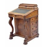 Victorian figured walnut davenport, with raised back and hinged cover enclosing a fitted