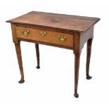 Georgian oak lowboy, the moulded top over a single long drawer, raised on circular tapering legs and