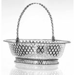 Edwardian oval pierced silver basket, with a swing handle and rope twist borders, engraved crest