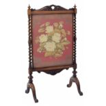 Victorian rosewood glazed fire screen, the embroidered floral image framed behind glass raised on