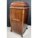 20th century cabinet gramophone, within a satin case on castors, 23" wide, 24" deep, 49" high (
