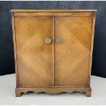 Art Deco style oak veneered cupboard, with quarter veneer doors and fancy brass handles, enclosing a
