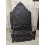 Cast iron fire back, the shaped arched back over a figural interior scene, 33" high, with a fire