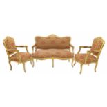Decorative French gilt suite comprising a settee and a pair of armchairs, the scrolling carved frame
