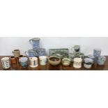 Selection of decorative pottery, primarily mugs and cups, including Highland stoneware, Burleigh,