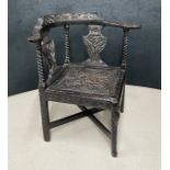 Victorian ebonised carved oak corner chair, 39" wide