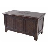 Small antique oak triple panelled coffer, the hinged top with carved floral medallion to the